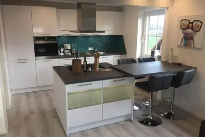 Image de \"Feel Good\" - Spacious apartment with balcony, garden view and modern furnishings.