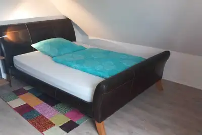 Image de Cozy attic apartment with large living room, bedroom with king size bed.