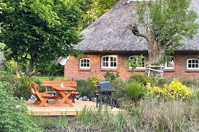 Image de Thatched roof house with lake and land