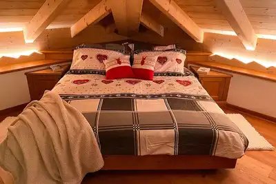Image de Attic room in typical mountain style, warm and cozy, complete with every comfort