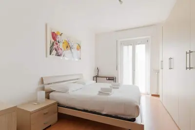 Image de GuestHost - A comfortable and bright 57 square meters apartment, perfect for four people, located on the first floor of a building with an elevator (Not accessible to disabled guests). The property is located halfway between Lambrate and Udine, a quiet ar