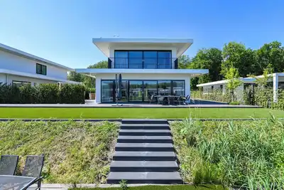 Image de Brand-new 8-person waterfront villa with hot tub, sauna and trampoline – perfect for a luxury family getaway.