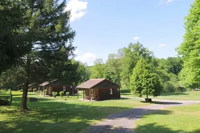 Image de Cozy wooden chalets with terrace on forest edge facing a running stream.