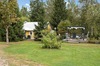 Image de Holiday in the forest by the river with boat, canoe and hot tub