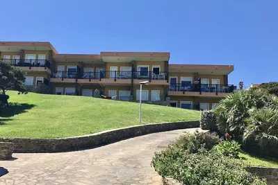 Image de Functional 28 sq m room. Comprising a double bed, two single beds, and a private bathroom with shower, bidet, and hairdryer. The room also features an outdoor space with a sea view, a patio or terrace, and a table and chairs. Breakfast is included in the