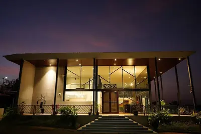 Glass House Surrounded By Hills