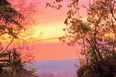 Image de Unique A-frame retreat right on the river and steps to the beach.