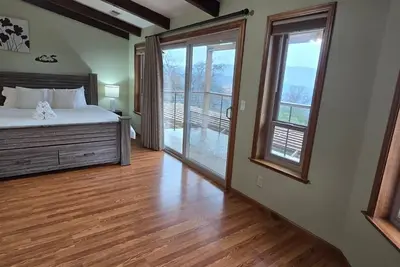 Sunlit Modern Retreat with Wraparound Deck & Sustainable Design