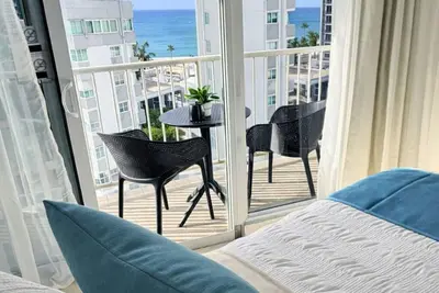 Image de Refined apartment with partial ocean-view balcony, steps from Condado Beach.