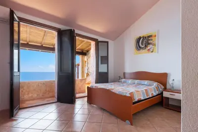 Image de The house is located in the heart of the residential and tourist district of Porto Corallo, a hamlet of the municipality of Villaputzu, on the south-eastern coast of Sardinia. The area is known for its natural beauty, tranquility and the presence of qual