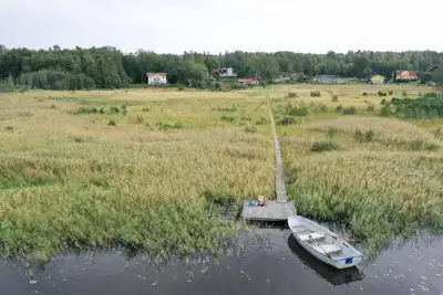 Image de Seaside plot with private jetty, rowing boat & sunset