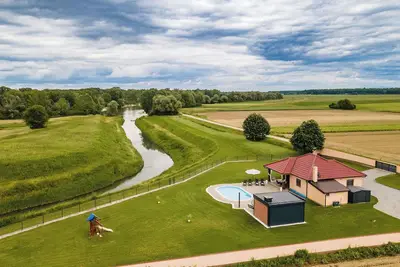 Image de Riverside retreat with pool, summer kitchen, playground, and peaceful Drava views.