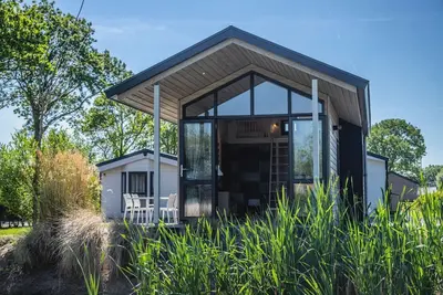Image de This detached lodge is surrounded by nature and gives you the feeling of a cozy hideaway, ideal for those who want to escape the hustle and bustle of everyday life for a while. Its location in the green polder landscape ensures peace and a beautiful