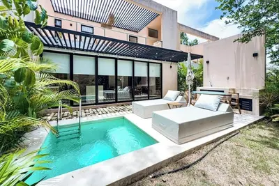 Image de Modern home with plunge pool, open layout, gym access, balcony, and W/D