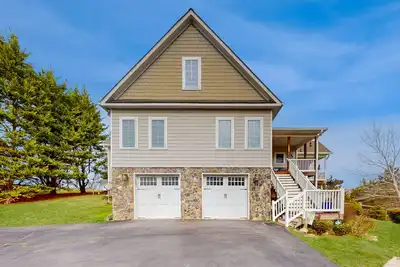 Nature lover's lakefront home with a beach, dock, fire ring, & more