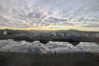 Image de Coastal Family Getaway Near Holden Beach with water views, covered patio & games