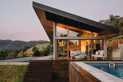 Image de Woodleigh Estate - Step into a world of timeless elegance and unparalleled charm at Woodleigh Estate. This historic 1860's home is nestled on a one acre estate landscaped with cottage like gardens. From the moment you enter the home you are envelope