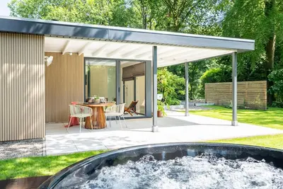 Image de Experience the ultimate vacation feeling in this secluded vacation home with a private wellness area, wood-burning stove, designer interior, and air conditioning