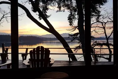 Image de Cabane en rondins en bord de mer avec des vues panoramiques sur l'océan, la montagne et le coucher du soleil