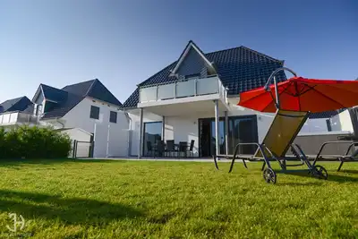 Image de Villa Fleesenstrand am See | avec bain à remous extérieur | Sky Tv | Cheminée | sauna