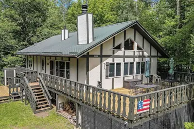 Image de Une maison de vacances confortable et spacieuse avec une superbe plate-forme enveloppante dans un cadre boisé et boisé