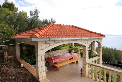 Image de Appartement de quatre chambres avec la terrasse et la vue sur le mer Prizba, Korcula (A-9227-d)