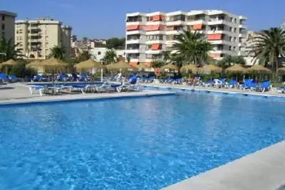 Image de La Nogalera terrasse ensoleillée dans complexe avec piscine, proche plage