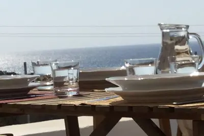Image de Sea Breeze Traditional Villa: plage aux eaux cristallines, piscine privée.