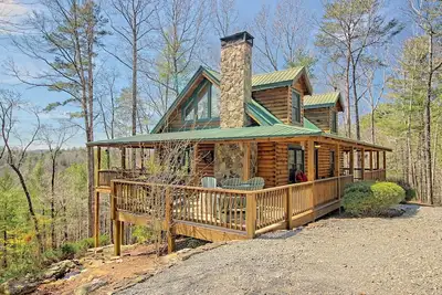 Image de Maison isolée sur une superficie avec bain à remous, foyer et terrasse enveloppante