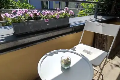 Image de Appartement avec une grande terrasse, partiellement couverte.