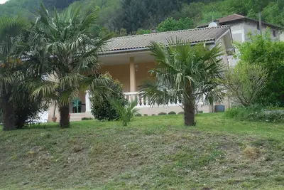 Image de maison Thueyts implantée dans un gd terrain avec lauriers roses et palmiers