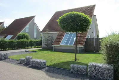 Image de Maison de vacances 5 * récemment rénovée dans le parc de vacances Zeeland Village Scharendijke - sauna