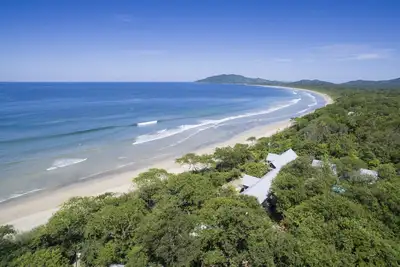 Cinq chalets, piscine et commodités au milieu d'une forêt en bord de mer.