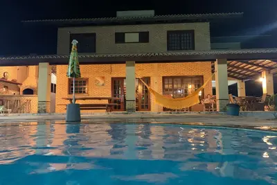 Image de Grande maison de plage avec vue sur la mer, piscine avec cascade et terrasse