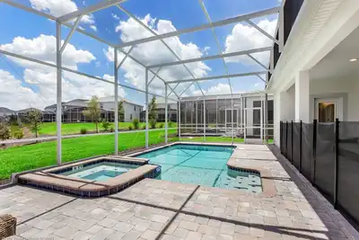 Image de Maison ChampionsGate avec piscine, spa, barbecue et salle de jeux