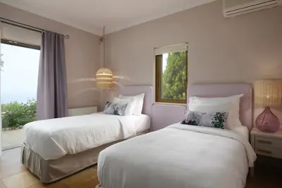Image de Villa de luxe sophistiquée avec piscine privée, vue panoramique sur la mer et coucher de soleil rêveur