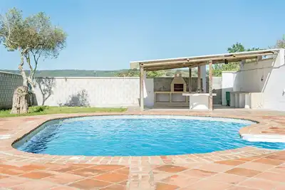 Image de Casa de Piedra avec une magnifique piscine de 50 mètres.