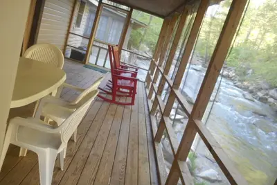 Image de On the River's Edge! ! Rocking chairs on large screened porch on river's edge.