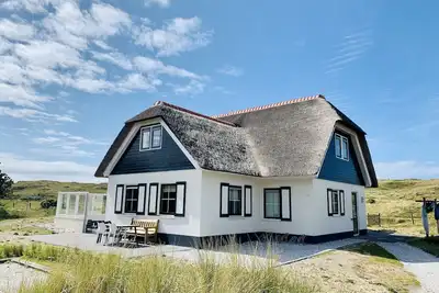 Luxurious dune villa on a walking distance to the beach with lighthouse view