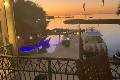Image de House and guest house with Boat dock, sunsets, jacuzzi, pool, slide, tiki, etc