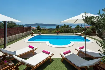 The house is located in a quiet mountain environment with panoramic sea views.