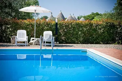 Image de Degli Archi: 1800s trullo house with hillside views and pool