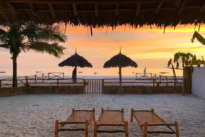 Villa Thamani beachfront and private beach with umbrellas