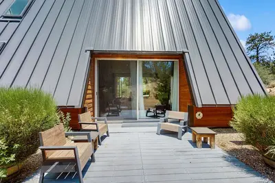 Image de Modern, cabin-Iinspired home with private hot tub, wood fireplace, and sauna