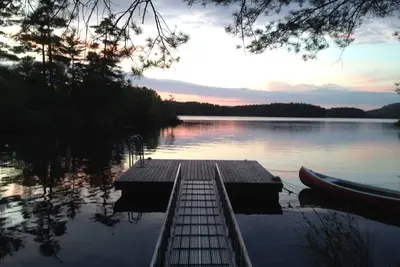 Image de Megunticook lakefront camp in Camden, Maine with large porch, dock & boats