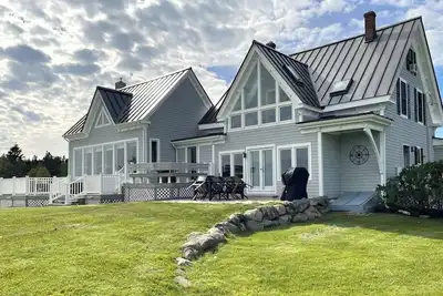 Image de Quintessential waterfront home with over 400 feet of private sandy beach.