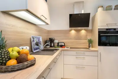 Image de Modern 2-room apartment with sauna and fireplace in the house.
