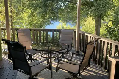 Image de Lakeside house with fireplace, deck, and a fenced backyard with firepit.