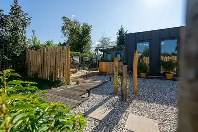 Image de This attractively furnished holiday home with a large terrace, is located on a quiet family park and close to the sea and beach.