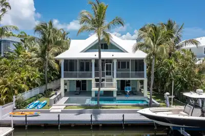 Image de Luxurious tropical water-front Heated pool home with Boat Dock and two master.